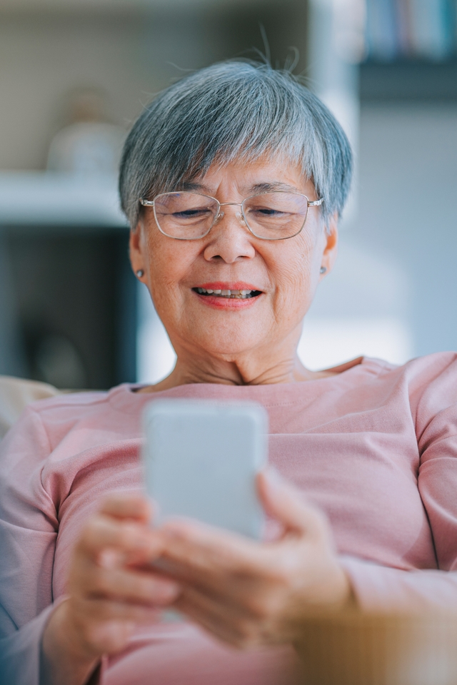 Elderly woman using her phone